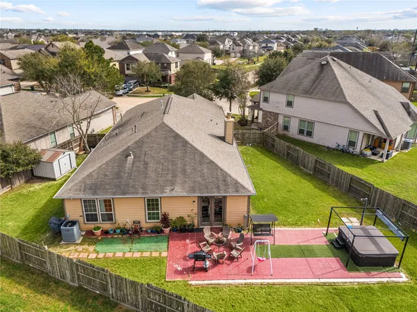 a aerial view of a house with swimming pool garden and patio