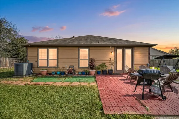 a view of a house with backyard sitting area and garden