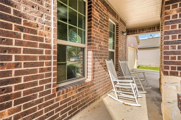 a view of a balcony with wooden floor and iron fence