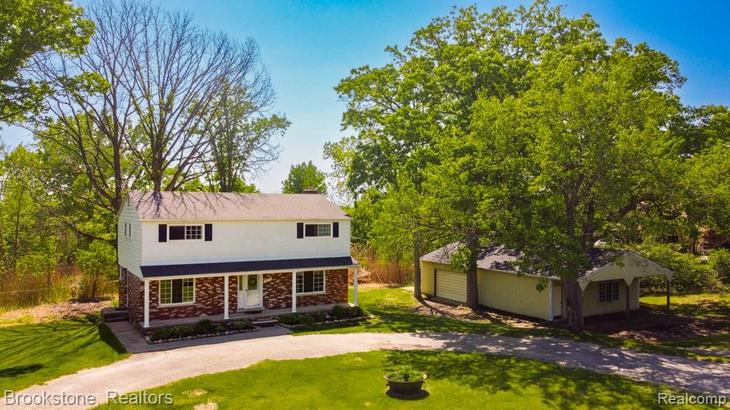 30100 Armada Ridge Road Richmond, MI 48062 - Photo 29 of 29 Two-story residence featuring a brick and white siding exterior, a covered porch, and black window shutters