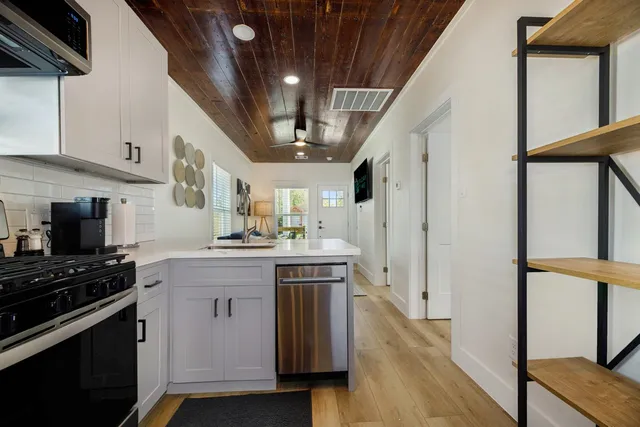 a kitchen with stainless steel appliances a stove a sink and a refrigerator
