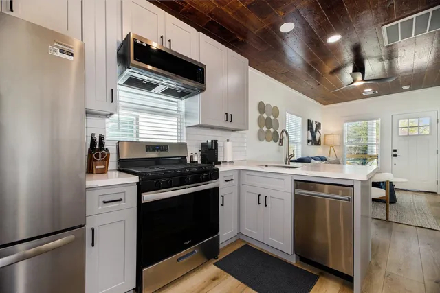 a kitchen with stainless steel appliances granite countertop a stove and a sink