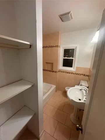 a bathroom with a sink a toilet and mirror