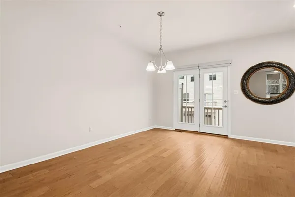 a view of a room with wooden floor and window