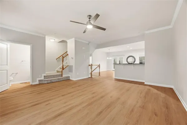 a view of empty room with wooden floor