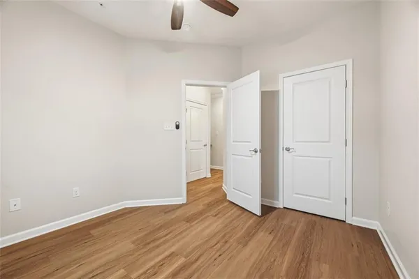 a view of an empty room with wooden floor