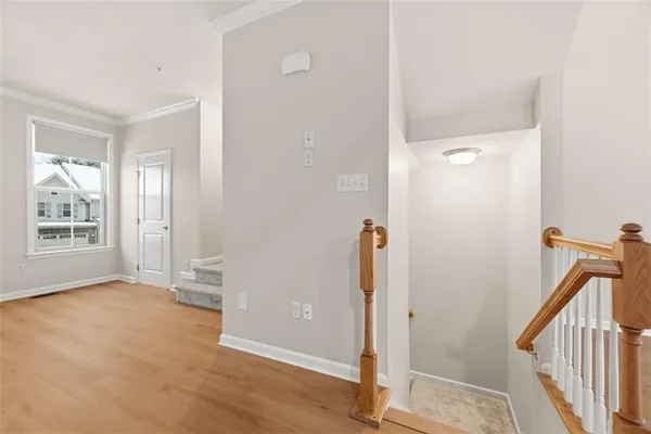 a view of entryway with wooden floor and mirror
