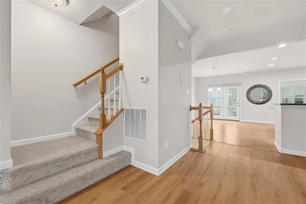 a view of entryway and hall with wooden floor