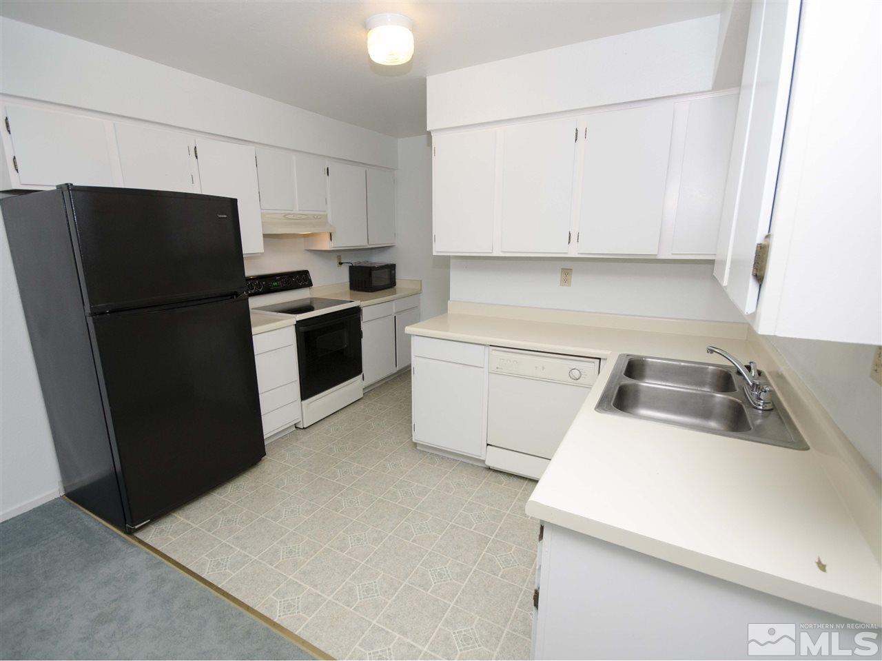 6640 Peppermint Drive Reno, NV 89506 - Photo 1 of 1 a kitchen with a refrigerator sink and cabinets