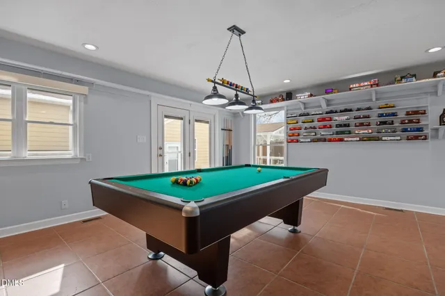 a view of backyard with wooden fence and large trees