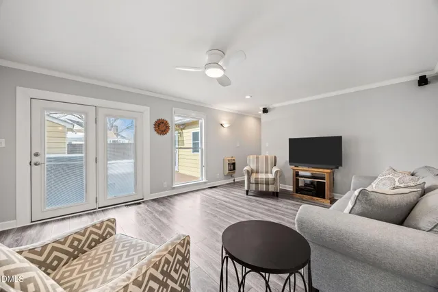 a living room with furniture and a wooden floor