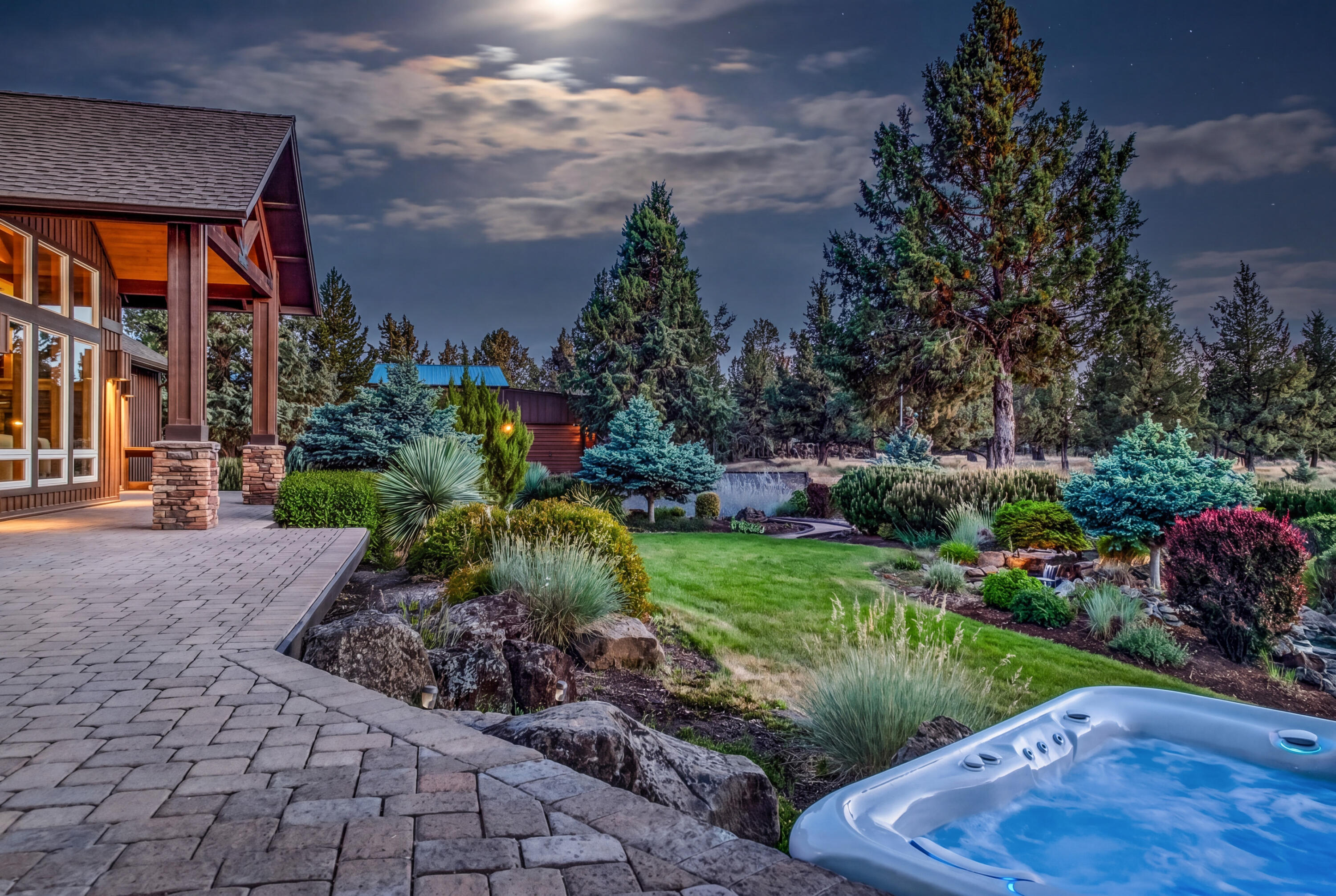 64145 Hunnell Road Bend, OR 97703 - Photo 24 of 65 Step outside from the private primary suite to a mountain-view patio with Hot Springs hot tub?an inviting retreat for soaking under the stars with Cascade views beyond.