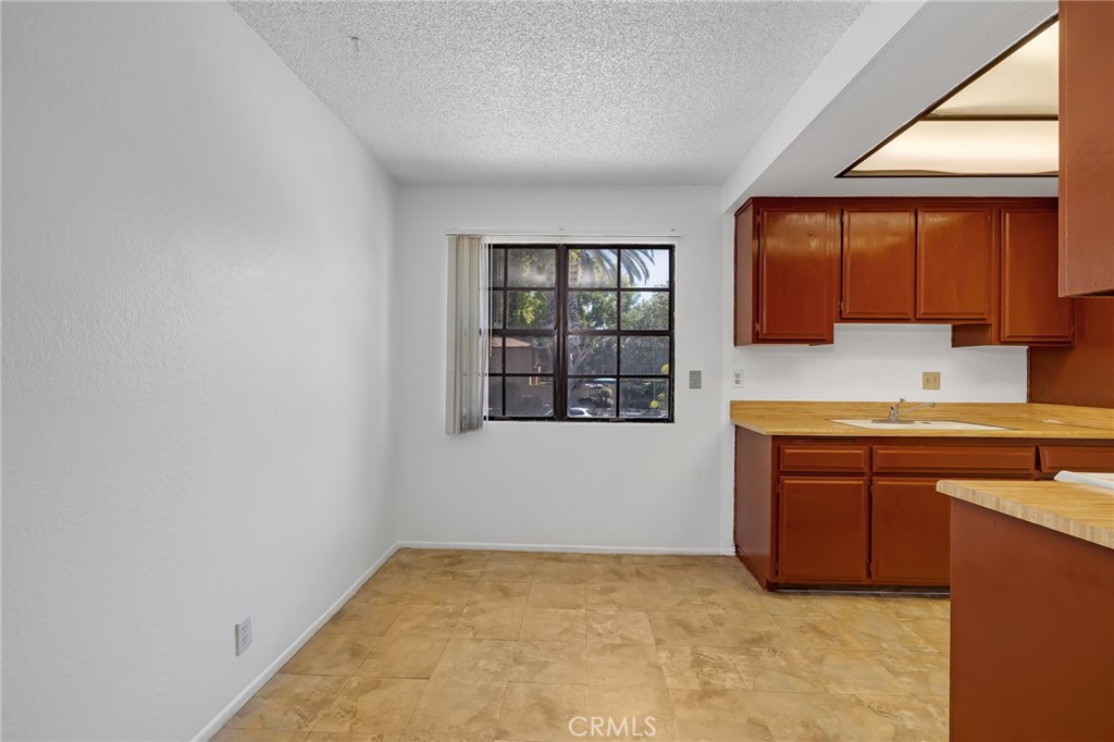 1629 West Ball Road Anaheim, CA 92802 - Photo 13 of 21 a kitchen with granite countertop a sink and a stove top oven