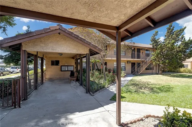 a view of swimming pool with outdoor seating and house in the background