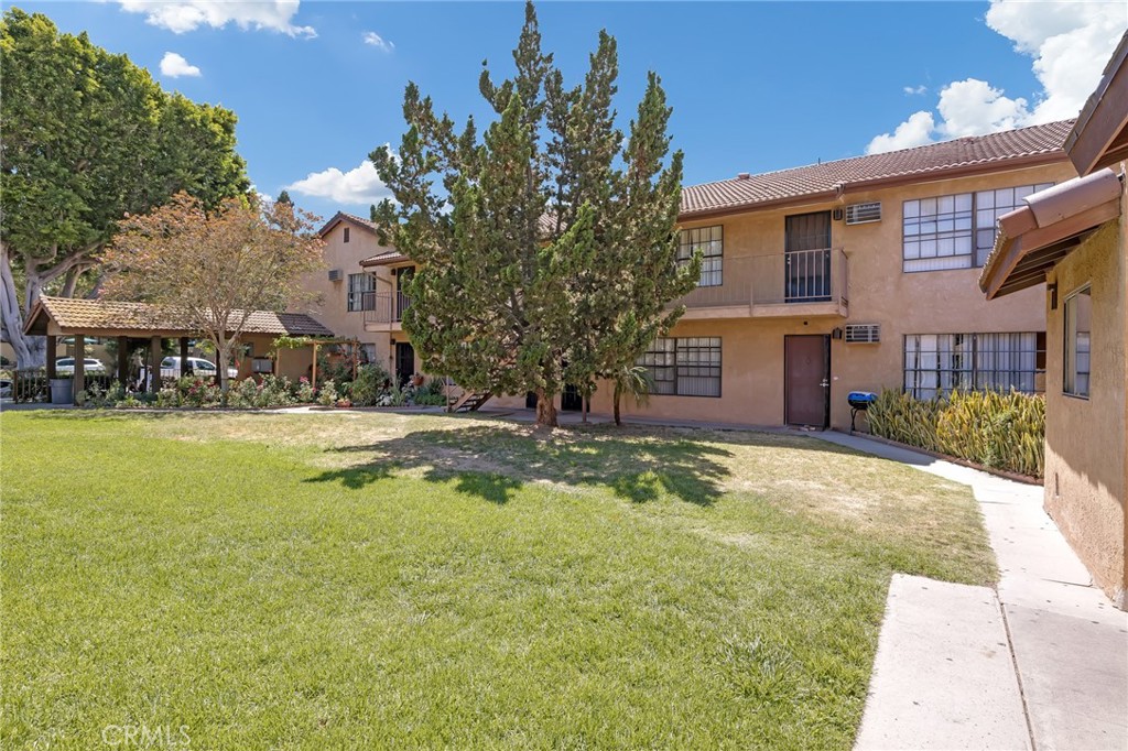 1629 West Ball Road Anaheim, CA 92802 - Photo 4 of 21 a view of swimming pool with outdoor seating and house in the background
