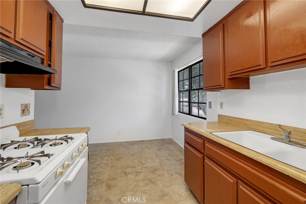 1629 West Ball Road Anaheim, CA 92802 - Photo 8 of 21 a kitchen with stainless steel appliances a stove and a refrigerator