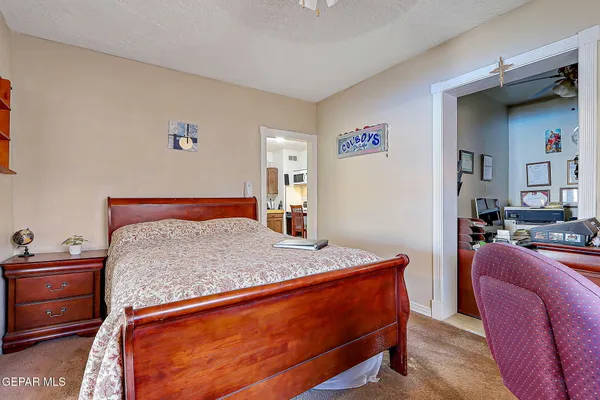 a bedroom with a bed and dresser