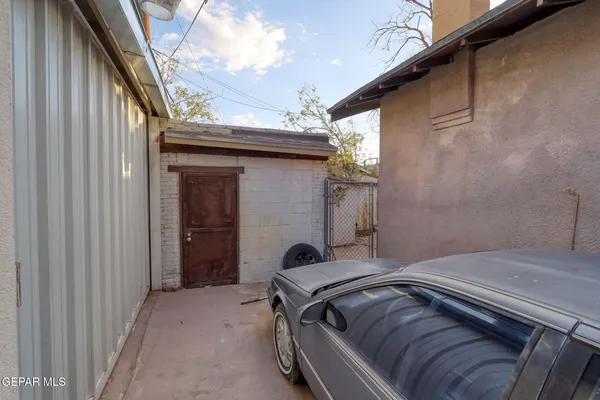 a view of backyard and a car parked in garage