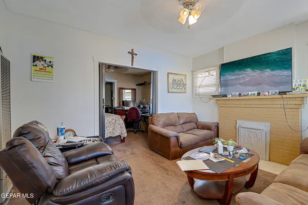 a living room with furniture a flat screen tv and a fireplace
