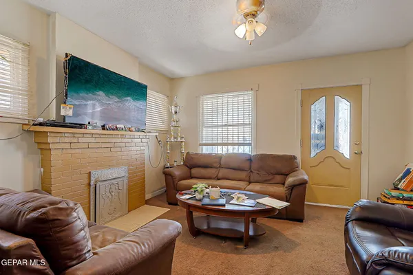 a living room with furniture a flat screen tv and a fireplace
