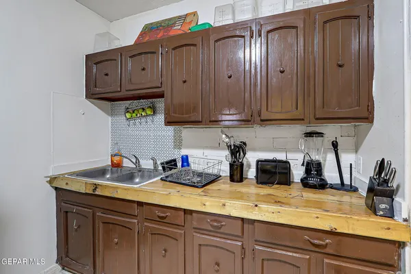 a kitchen with stainless steel appliances granite countertop a sink a stove and cabinets
