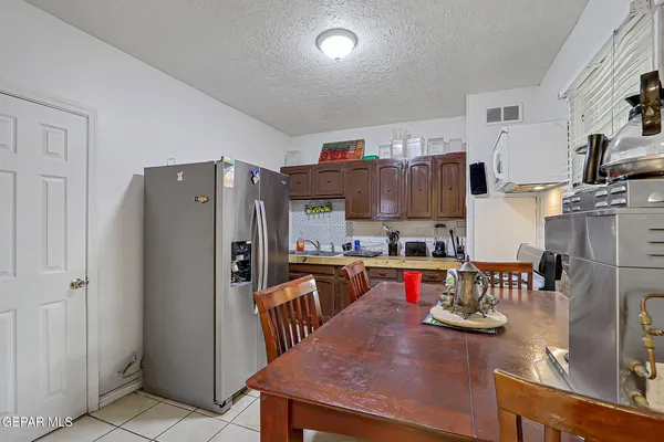 a kitchen with stainless steel appliances granite countertop a refrigerator and wooden floor