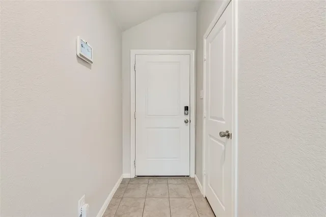 a view of kitchen with refrigerator and microwave