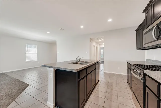 a kitchen with stainless steel appliances granite countertop a stove and a sink