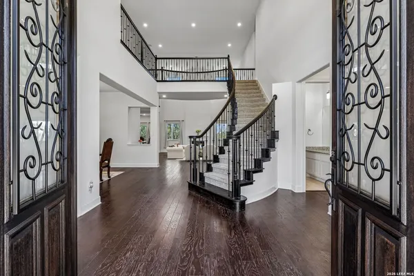 a view of entryway with wooden floor and stairs