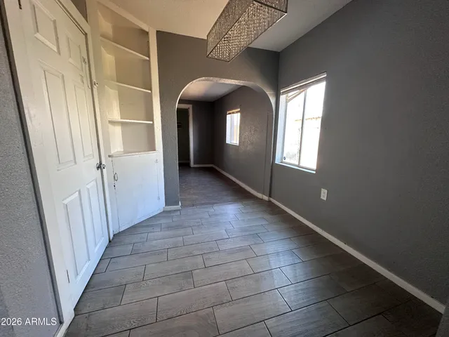 a kitchen with cabinets wooden floor and stainless steel appliances