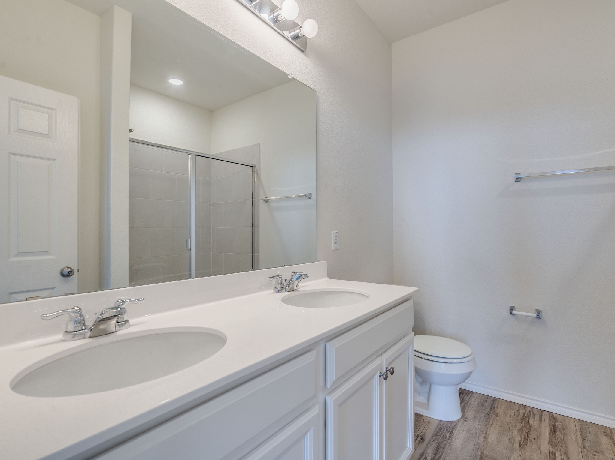 790 Pepperbark Loop Buda, TX 78610 - Photo 10 of 22 Dual vanity sinks and a tiled shower create a functional, refreshing bathroom space.
