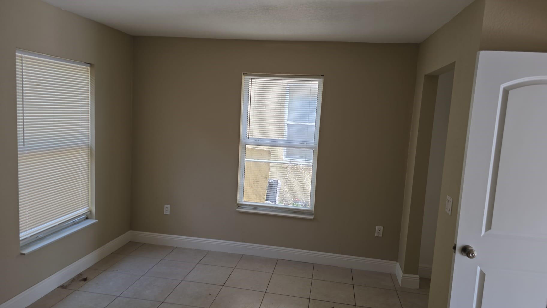 900 Avenue H, Unit 916 Riviera Beach, FL 33404 - Photo 3 of 4 a view of an empty room with closet and a window