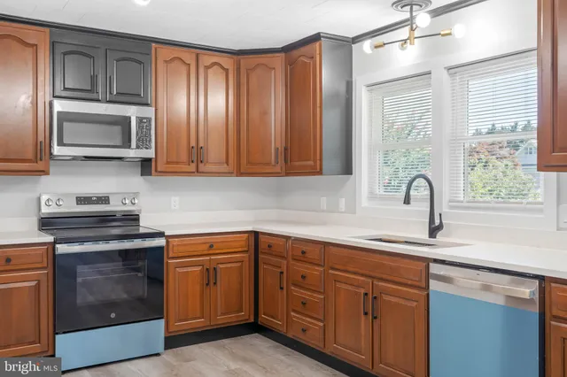 a kitchen with cabinets appliances and a window