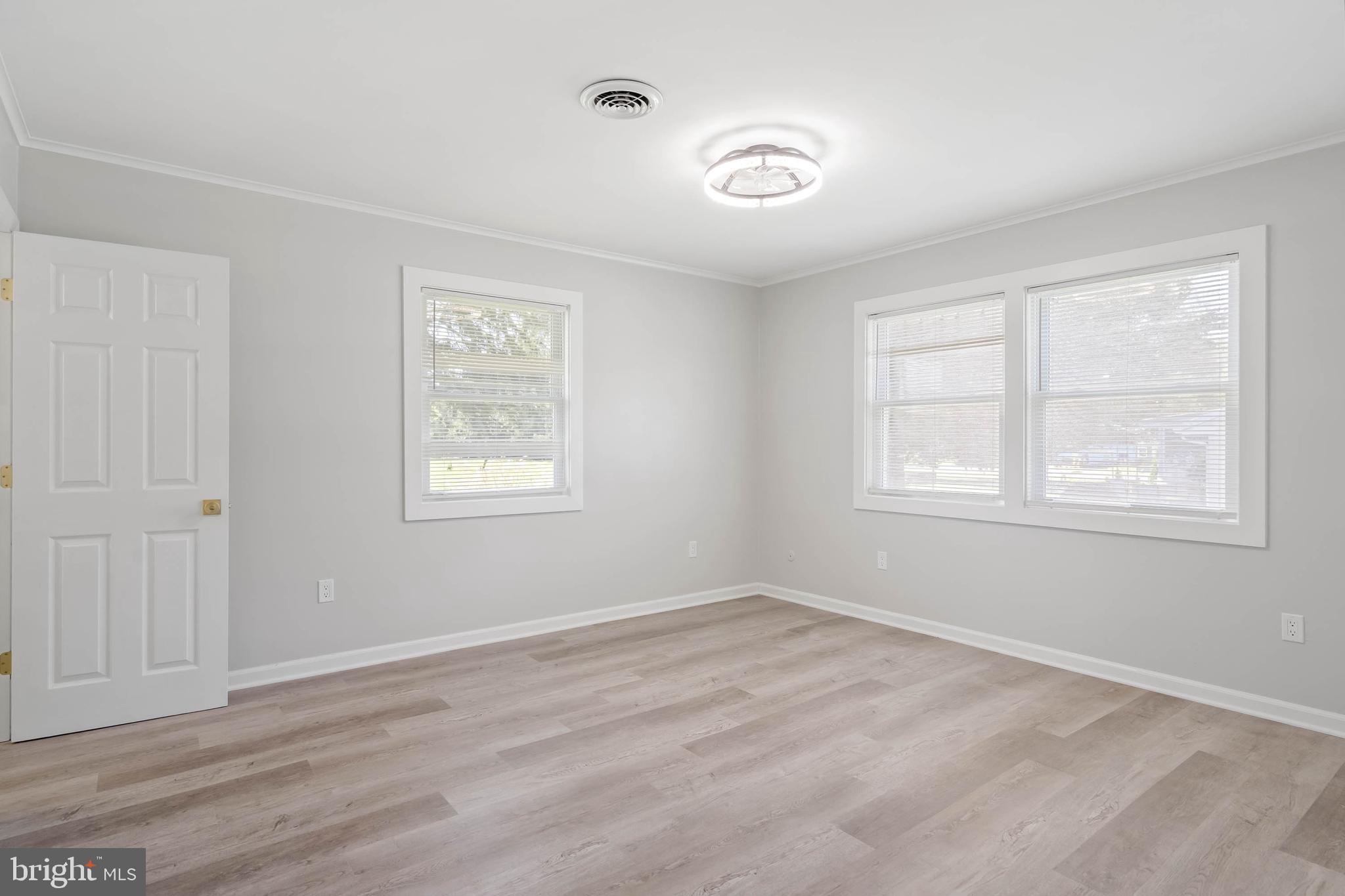 34132 Clay Road Lewes, DE 19958 - Photo 18 of 32 a view of an empty room with wooden floor and a window