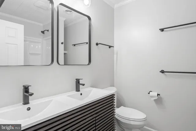a bathroom with a sink toilet and mirror