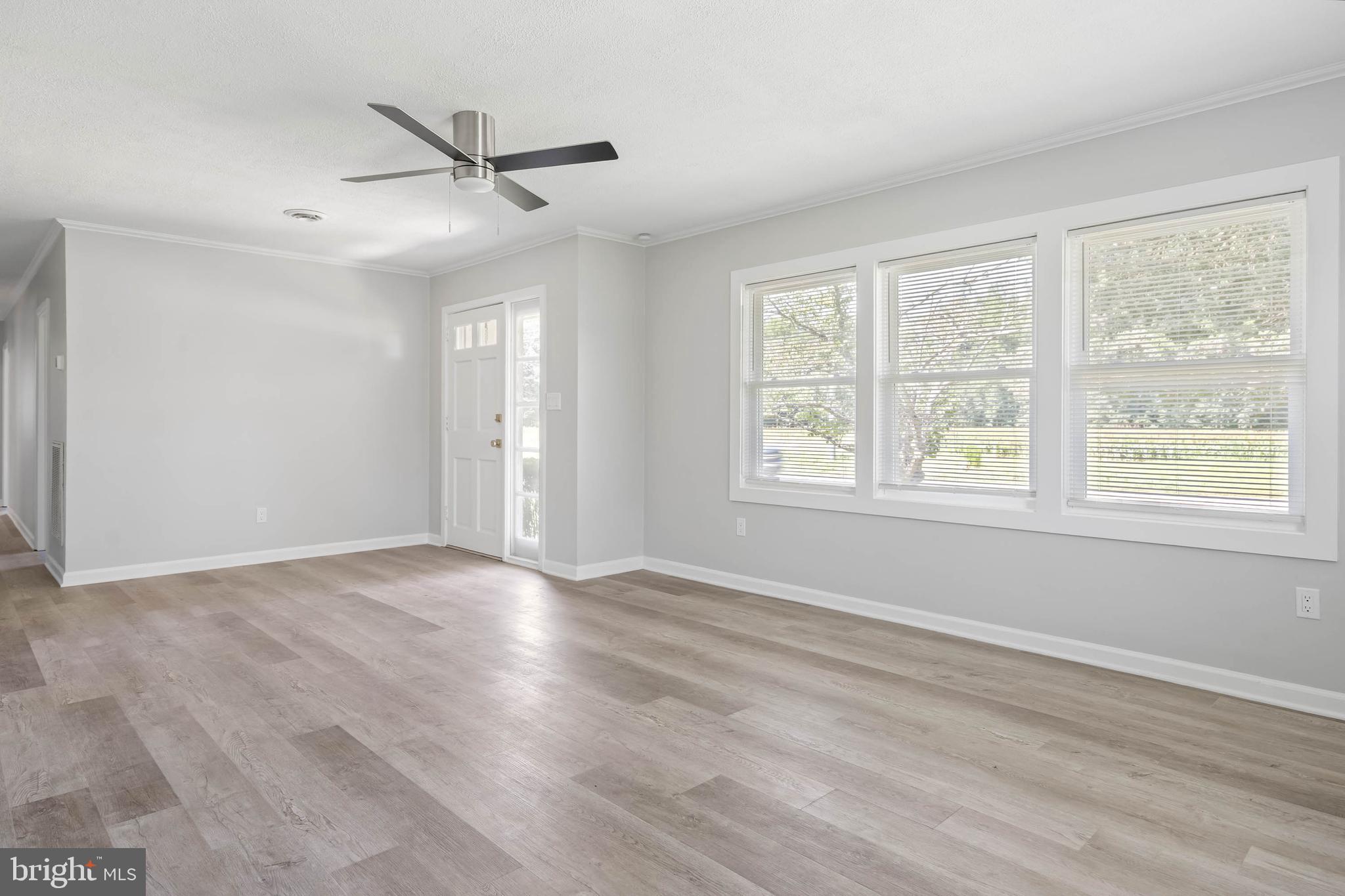 34132 Clay Road Lewes, DE 19958 - Photo 5 of 32 a view of an empty room with wooden floor and a window