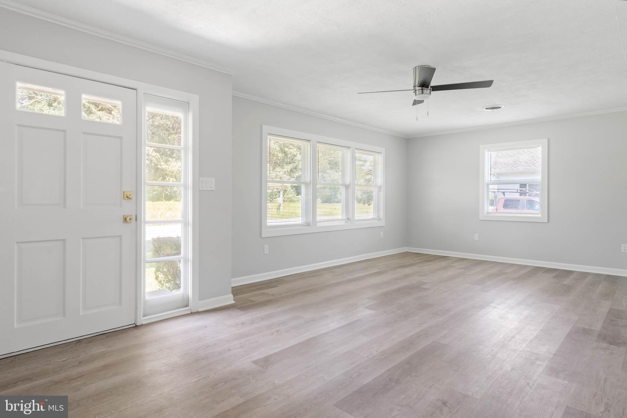 34132 Clay Road Lewes, DE 19958 - Photo 6 of 32 a view of an empty room with a window and wooden floor