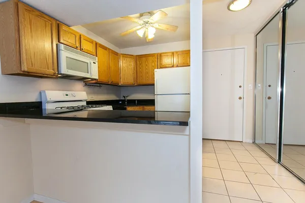 a kitchen with stainless steel appliances a refrigerator a stove a microwave and cabinets