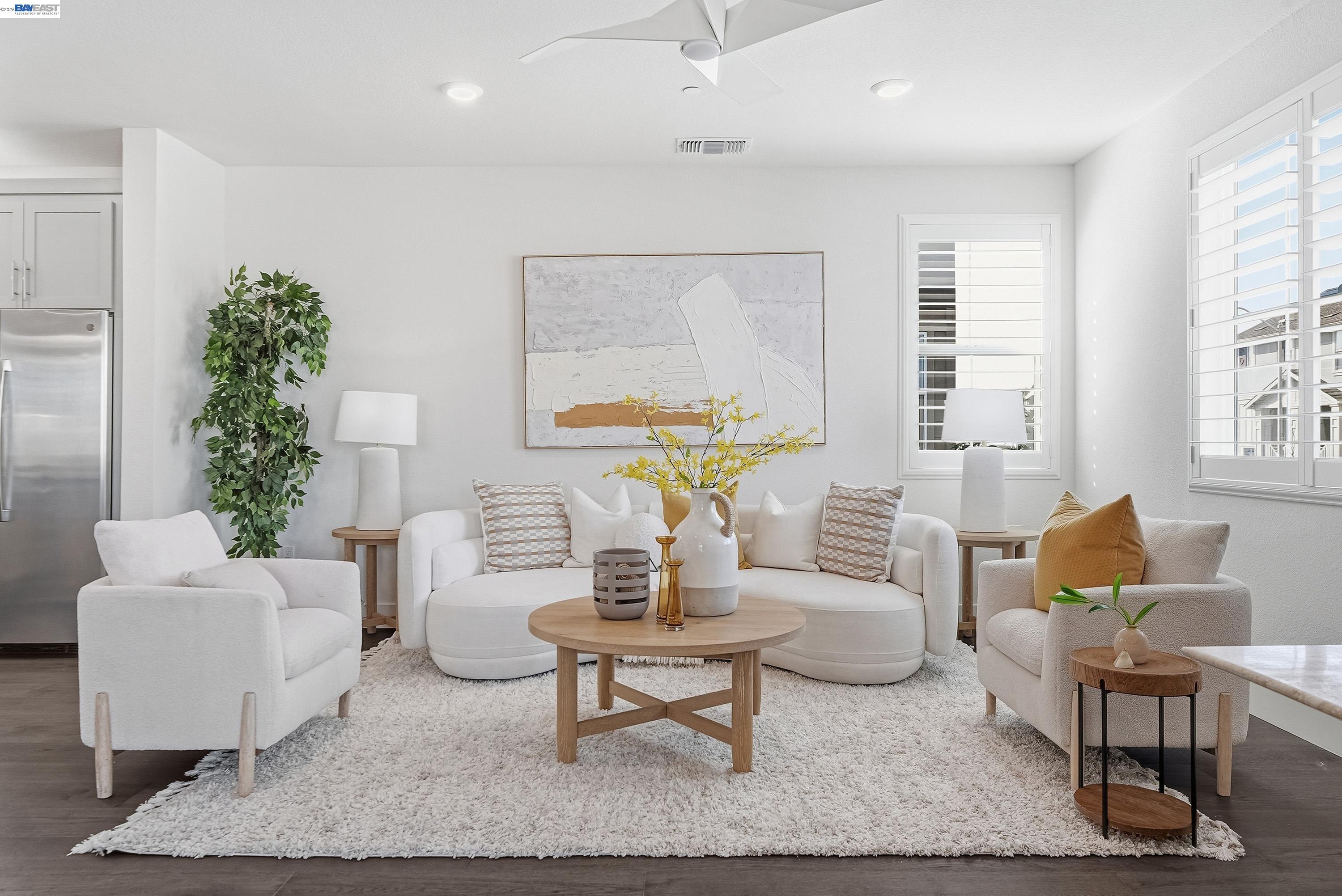 a living room with furniture a table and a potted plant