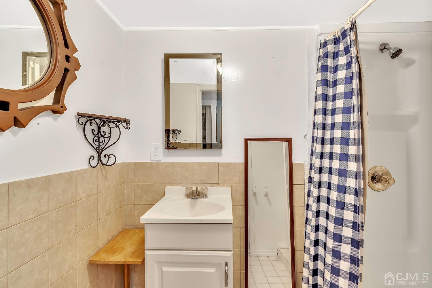 42 MacArthur Drive Edison, NJ 08837 - Photo 12 of 25 a bathroom with a sink a mirror and shower