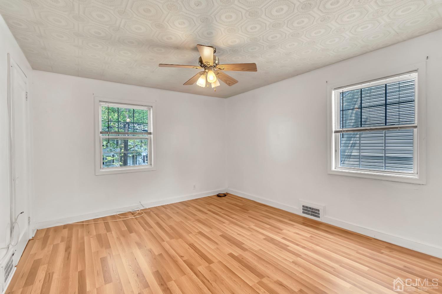42 MacArthur Drive Edison, NJ 08837 - Photo 16 of 25 a view of empty room with wooden floor and fan