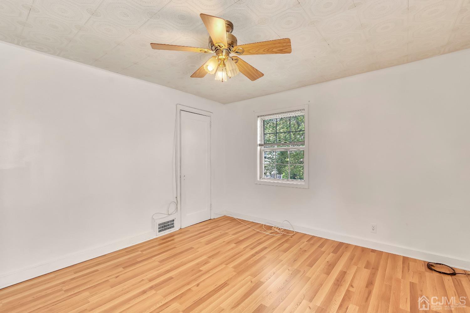 42 MacArthur Drive Edison, NJ 08837 - Photo 17 of 25 wooden floor in an empty room with a window