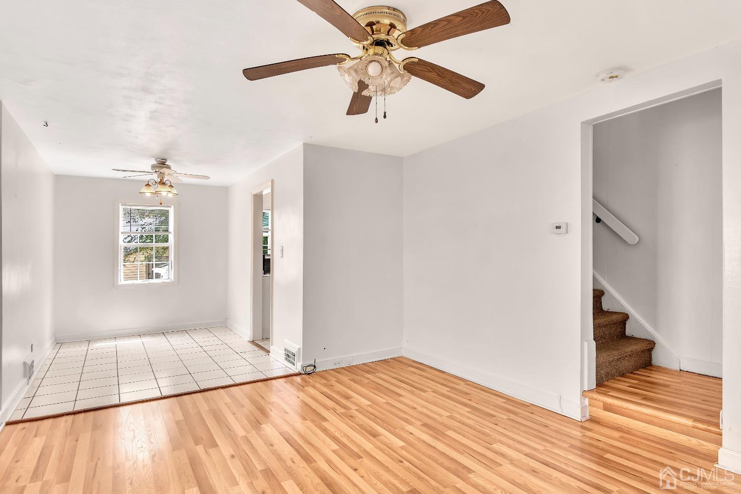 42 MacArthur Drive Edison, NJ 08837 - Photo 6 of 25 a view of a room with wooden floor and a ceiling fan