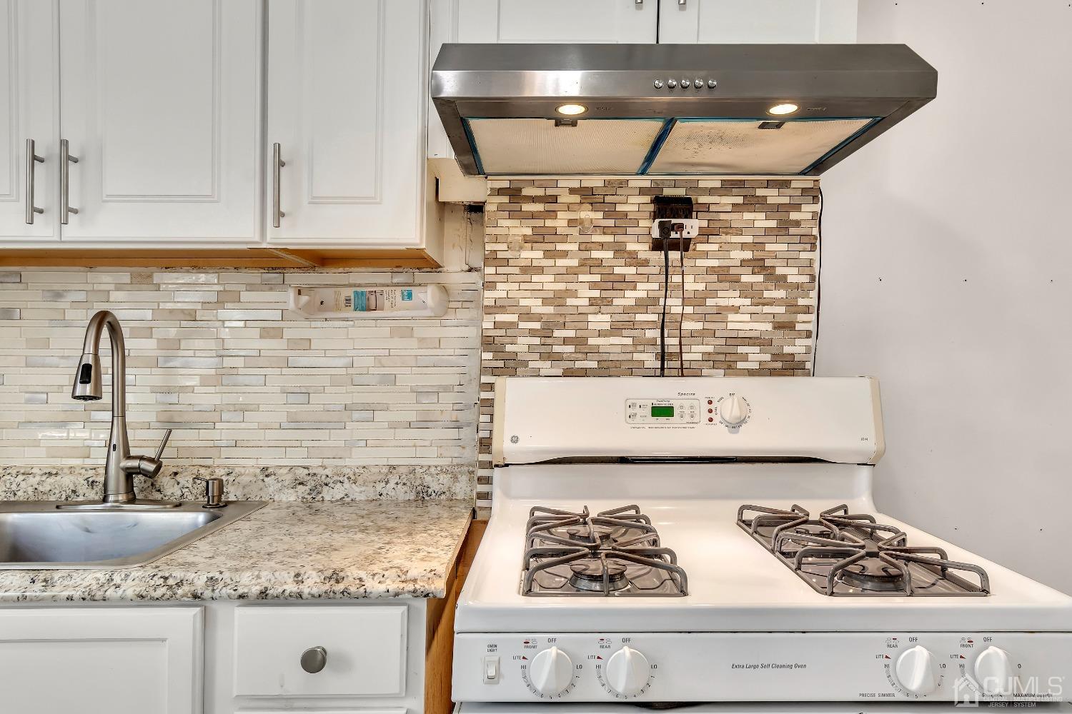 42 MacArthur Drive Edison, NJ 08837 - Photo 10 of 25 a kitchen with a stove and cabinets