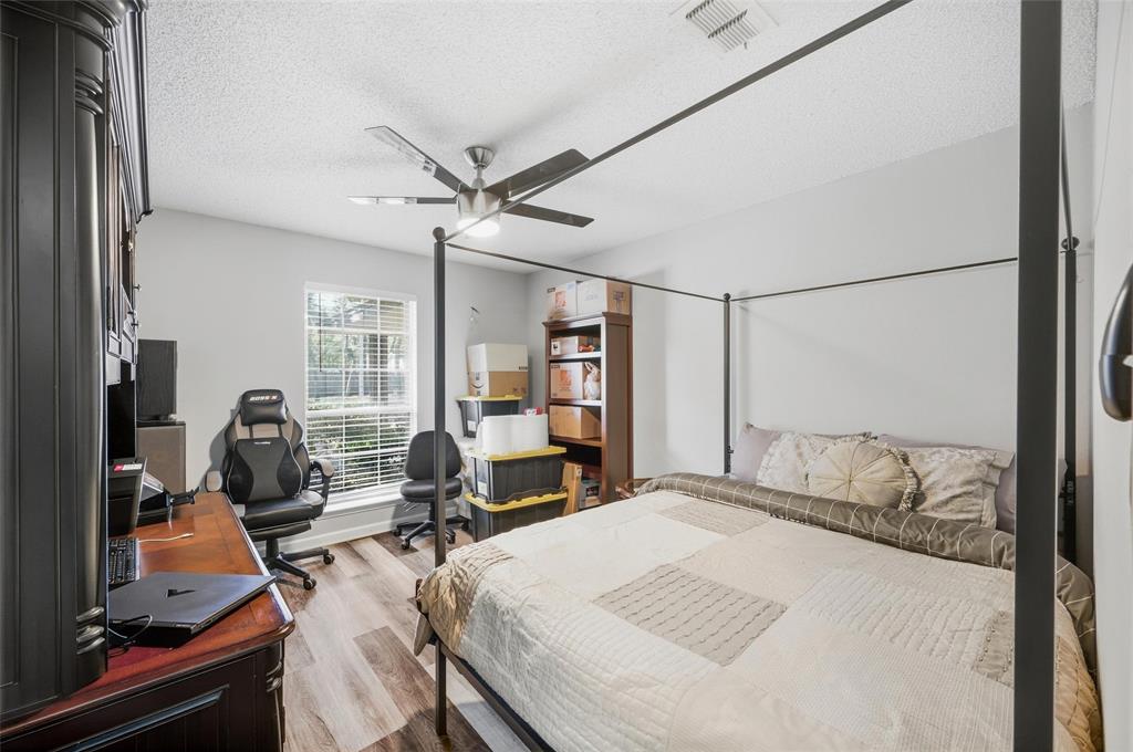 608 Ridgewood Circle Hurst, TX 76054 - Photo 19 of 38 Light-toned walls with wood-finish flooring, featuring a ceiling fan with integrated lighting