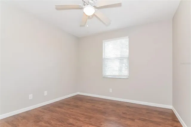 an empty room with wooden floor & closet