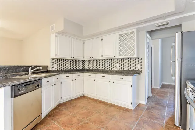 a view of a kitchen with granite countertop cabinets