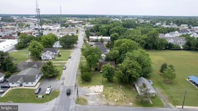 an aerial view of a house with a yard and lake view