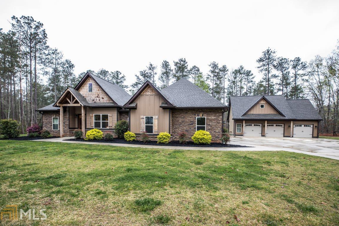 8530 Wilson Road Douglasville, GA 30135 - Photo 1 of 1 a front view of a house with a garden and trees