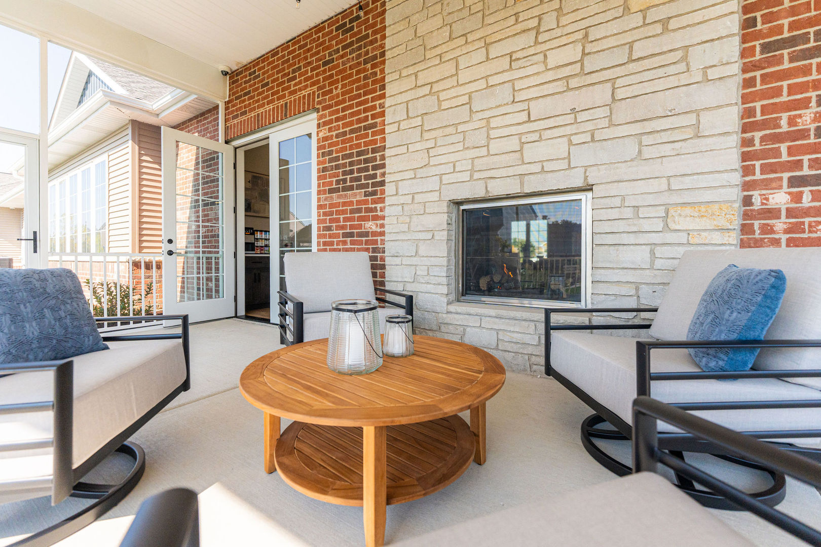 52 Kloe Lane, Unit 52 Sycamore, IL 60178 - Photo 26 of 32 a living room with patio furniture and a fireplace